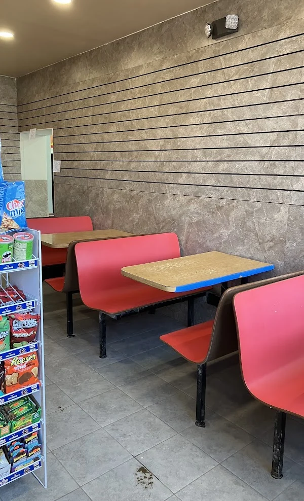 Red booth seating with wooden tables along the wall