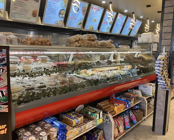 Deli counter case filled with salads, sandwiches and desserts