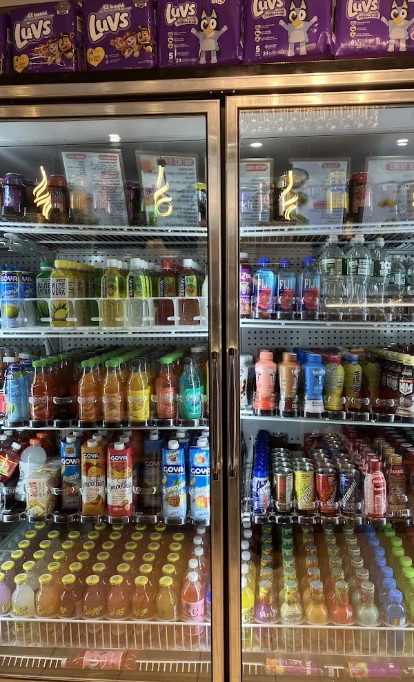 Two glass door coolers full of juice, water, soda and iced tea